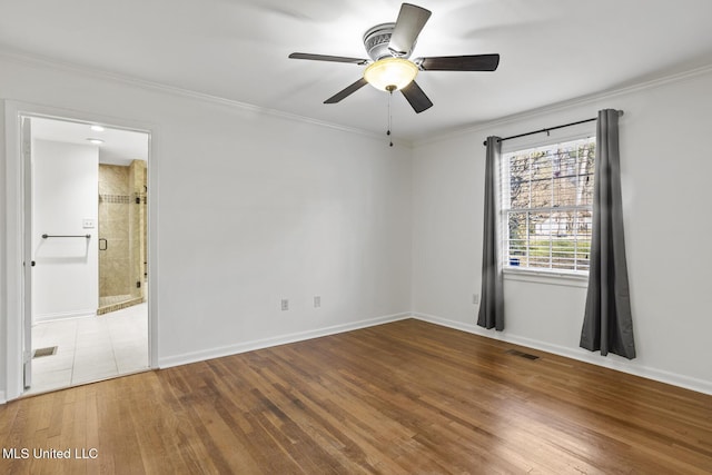 spare room featuring hardwood / wood-style floors, ceiling fan, and ornamental molding