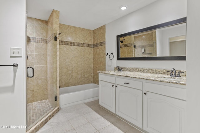 bathroom featuring plus walk in shower, tile patterned flooring, and vanity