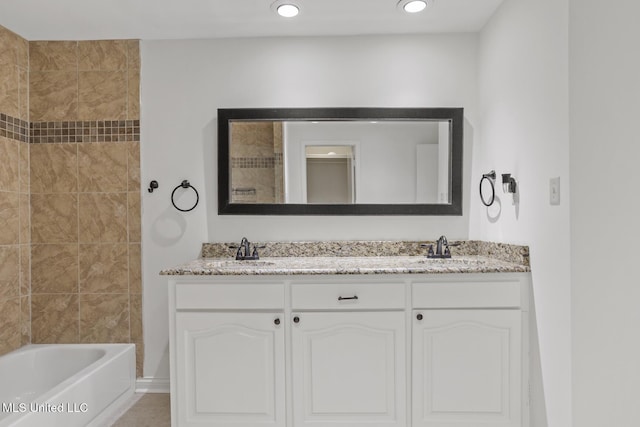 bathroom with vanity and tiled shower / bath combo