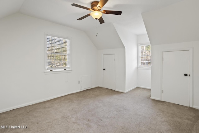 additional living space with light carpet, vaulted ceiling, and ceiling fan