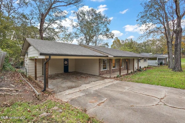 ranch-style home featuring a front yard and a carport