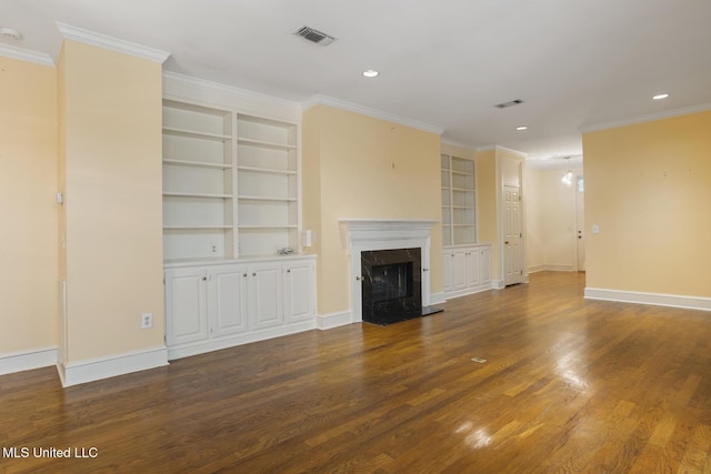 unfurnished living room with built in shelves, wood finished floors, a high end fireplace, baseboards, and crown molding