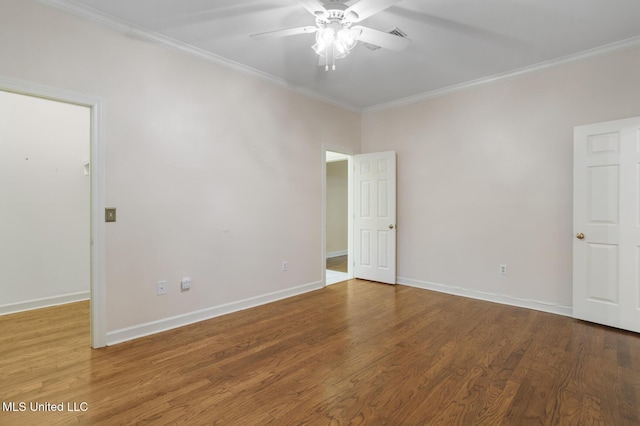 empty room featuring ornamental molding, ceiling fan, baseboards, and wood finished floors