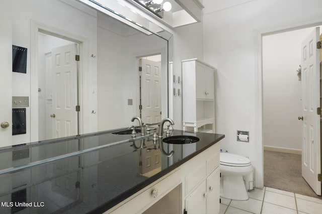 bathroom featuring tile patterned floors, toilet, and vanity