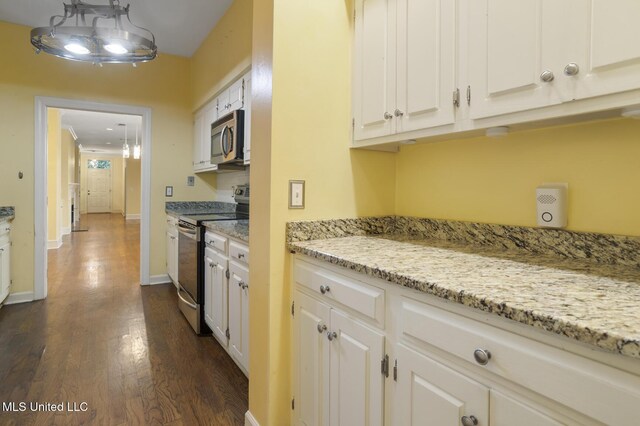 kitchen featuring stainless steel appliances, dark wood finished floors, white cabinetry, and light stone counters