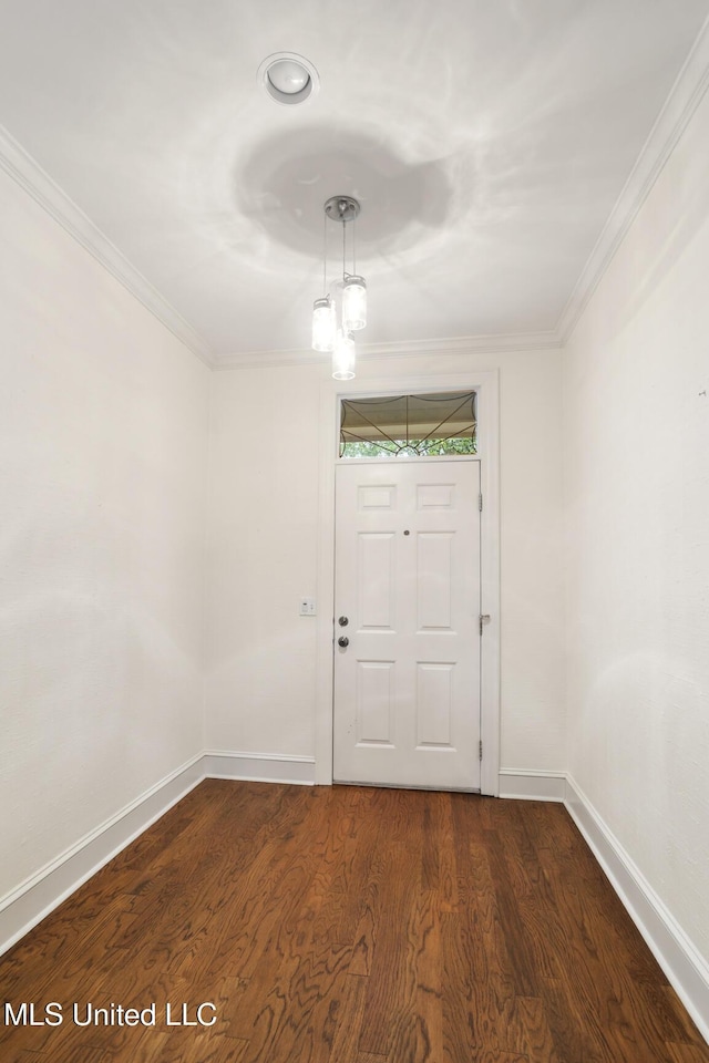 unfurnished room featuring baseboards, dark wood-type flooring, and crown molding