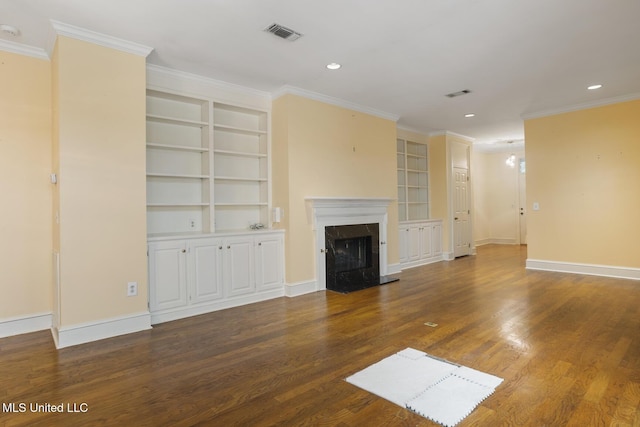 unfurnished living room featuring built in features, wood finished floors, a high end fireplace, baseboards, and crown molding