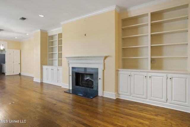 unfurnished living room featuring built in shelves, ornamental molding, dark wood-style flooring, a fireplace, and baseboards