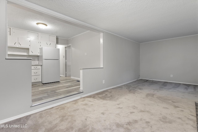 unfurnished living room featuring light carpet, crown molding, and a textured ceiling