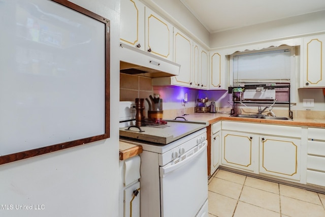 2211 Popps Ferry Rd, Biloxi, MS 39532 - kitchen with white range oven, a sink, under cabinet range hood, light tile patterned floors, and light countertops