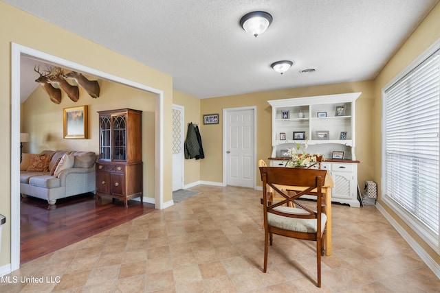 home office featuring a textured ceiling and light wood-type flooring