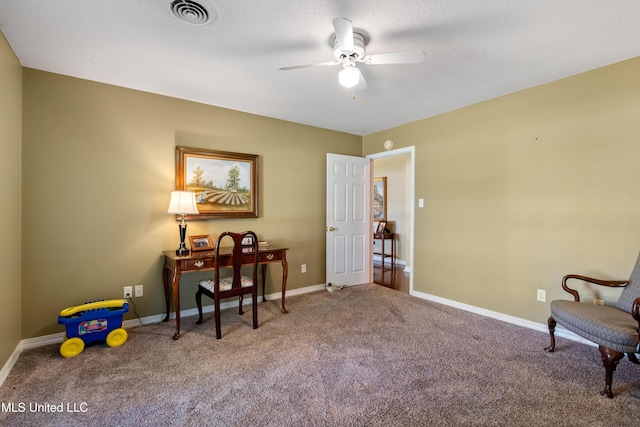 carpeted office space with ceiling fan