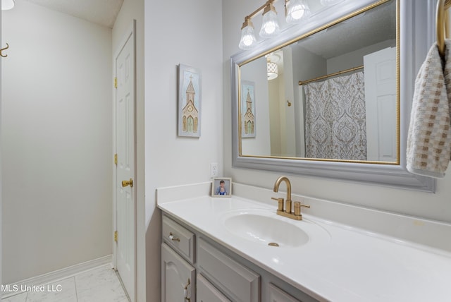 bathroom with tile patterned flooring, vanity, and a textured ceiling