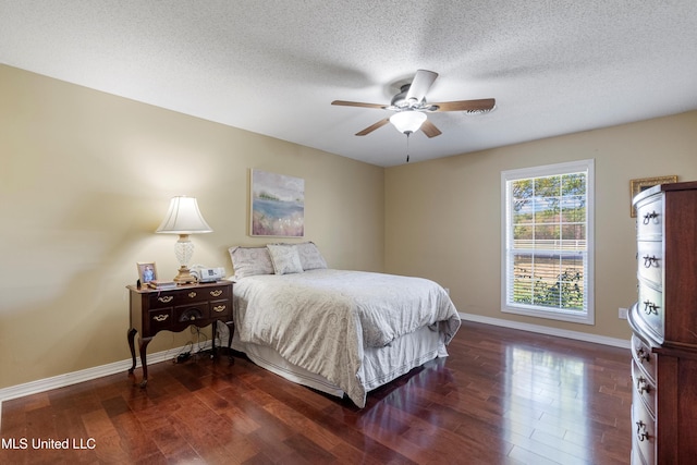 bedroom with a textured ceiling, ceiling fan, and dark hardwood / wood-style floors