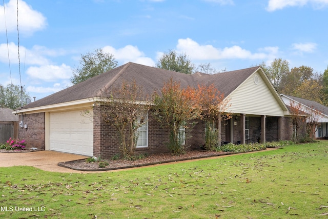 view of front of home featuring a front yard and a garage