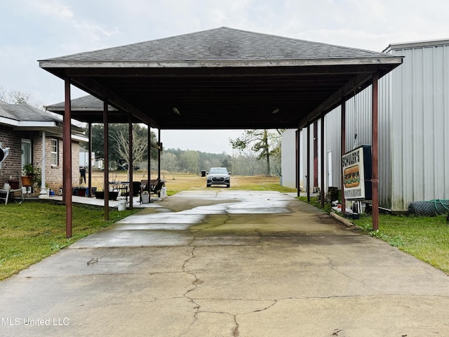 view of parking / parking lot featuring a lawn