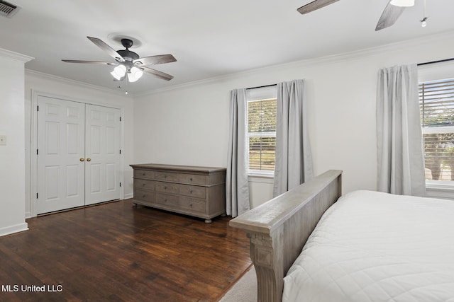 bedroom featuring dark wood-style flooring, multiple windows, crown molding, and visible vents