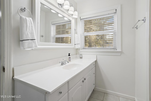 bathroom with tile patterned flooring, plenty of natural light, vanity, and baseboards