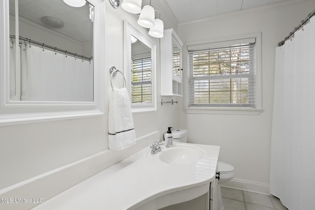 bathroom featuring toilet, vanity, baseboards, ornamental molding, and tile patterned floors