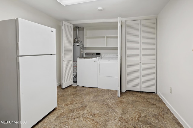 washroom with water heater, laundry area, separate washer and dryer, and baseboards