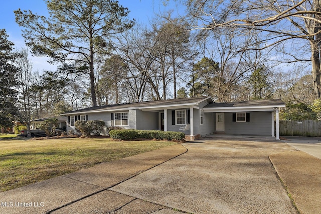 ranch-style home featuring fence, an attached carport, concrete driveway, and a front yard