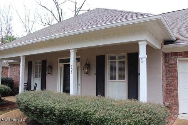 exterior space featuring a garage and covered porch