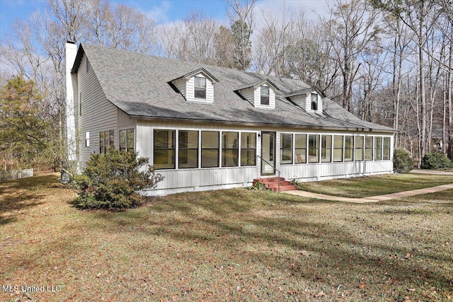 cape cod home with a sunroom and a front lawn