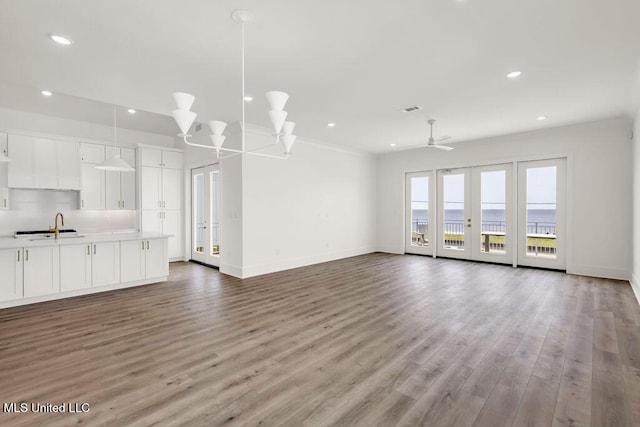26470 W Beach Blvd, Pass Christian, MS 39571 - unfurnished living room featuring french doors, recessed lighting, wood finished floors, and ceiling fan