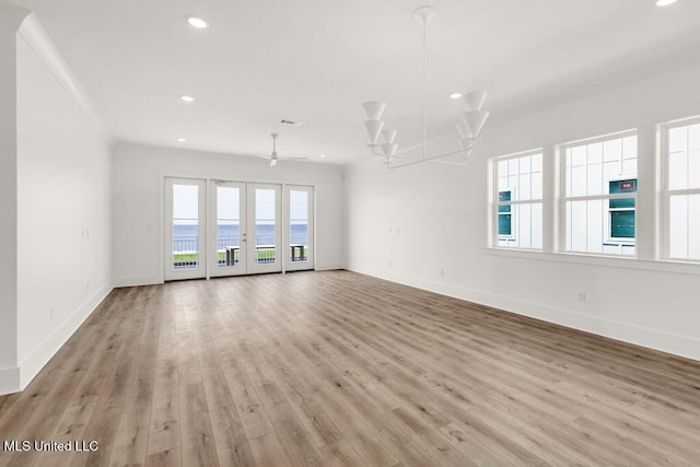 26470 W Beach Blvd, Pass Christian, MS 39571 - unfurnished living room featuring light wood finished floors, recessed lighting, french doors, and crown molding