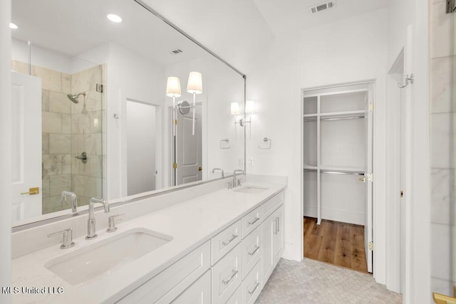 26470 W Beach Blvd, Pass Christian, MS 39571 - full bathroom featuring a stall shower, double vanity, recessed lighting, and a walk in closet