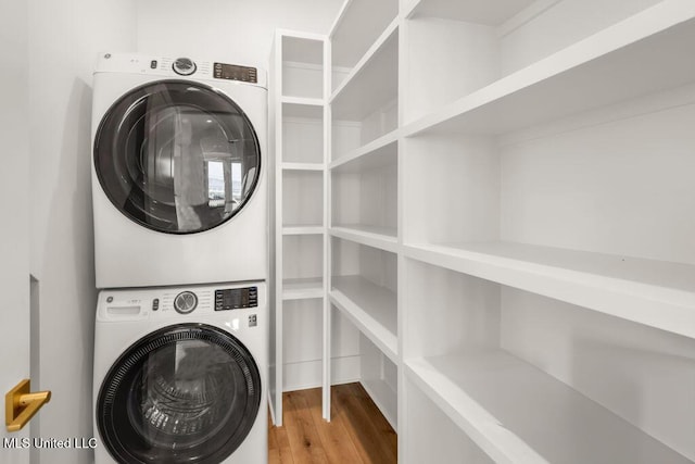 26470 W Beach Blvd, Pass Christian, MS 39571 - laundry room featuring estacked washer and dryer and wood finished floors