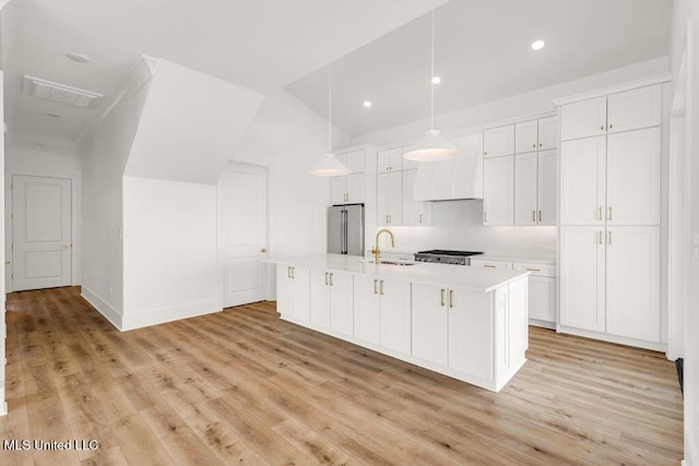 26470 W Beach Blvd, Pass Christian, MS 39571 - kitchen with appliances with stainless steel finishes, light countertops, light wood-style floors, white cabinets, and recessed lighting