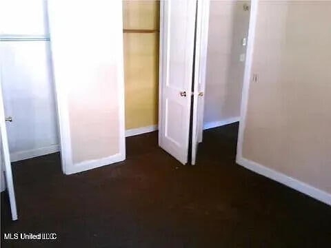 2931 Barwood Dr, Jackson, MS 39212 - unfurnished bedroom with baseboards and a closet