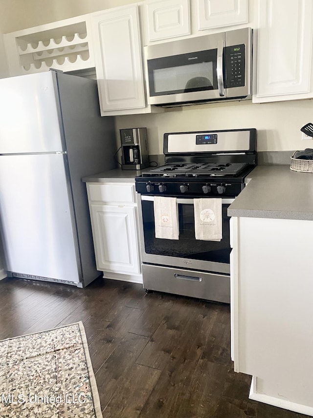 2252 Beach Dr Unit 203, Gulfport, MS 39507 - kitchen with stainless steel appliances, dark wood-style flooring, and white cabinets