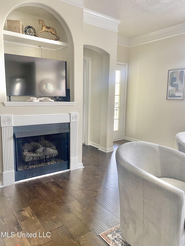 2252 Beach Dr Unit 203, Gulfport, MS 39507 - living room with hardwood / wood-style flooring, crown molding, a textured ceiling, a fireplace, and arched walkways