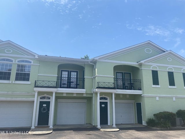 2252 Beach Dr Unit 203, Gulfport, MS 39507 - view of front of home with a balcony, a garage, and stucco siding