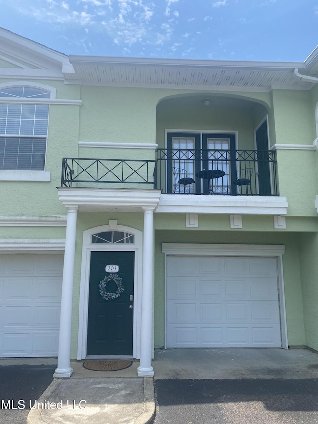 2252 Beach Dr Unit 203, Gulfport, MS 39507 - entrance to property with a balcony, stucco siding, and an attached garage