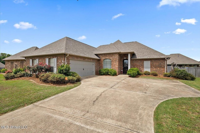 ranch-style house featuring brick siding, a garage, a front yard, and a shingled roof