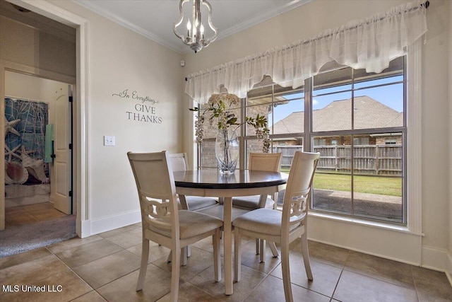 tiled dining space featuring baseboards, a chandelier, and ornamental molding