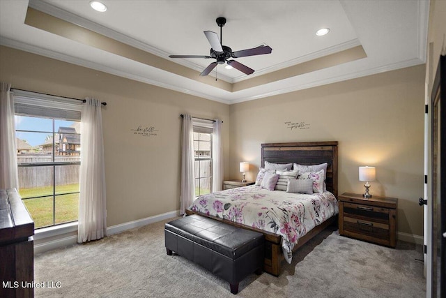 carpeted bedroom with baseboards, ornamental molding, a tray ceiling, and recessed lighting