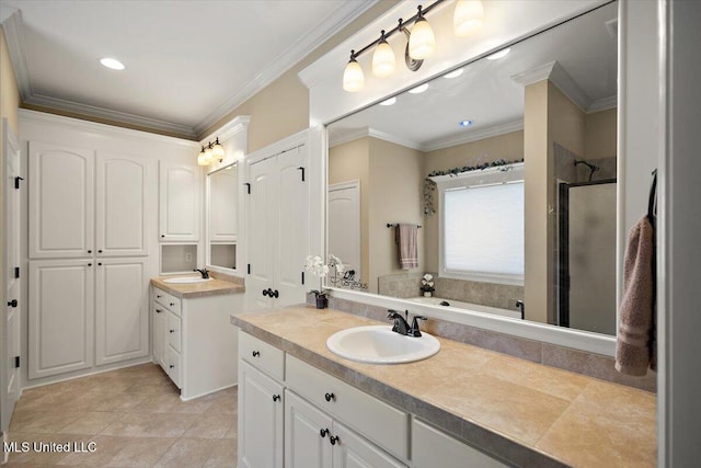 full bathroom with crown molding, two vanities, a sink, and a stall shower