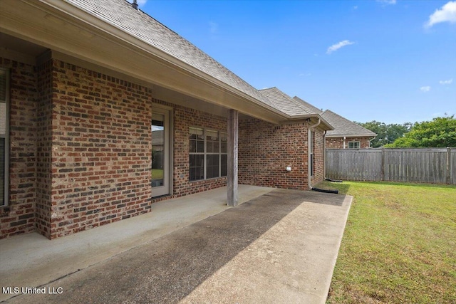 view of yard with fence and a patio