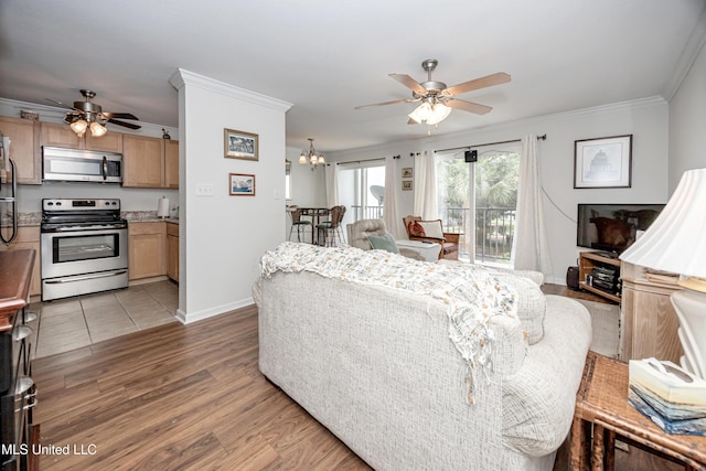 3230 Cumberland Rd Unit 18, Ocean Springs, MS 39564 - living room featuring baseboards, crown molding, light wood finished floors, and ceiling fan with notable chandelier