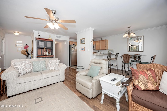 3230 Cumberland Rd Unit 18, Ocean Springs, MS 39564 - living area with visible vents, ornamental molding, ceiling fan with notable chandelier, and wood finished floors