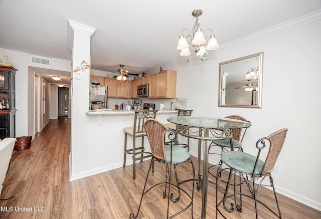 3230 Cumberland Rd Unit 18, Ocean Springs, MS 39564 - dining space with visible vents, crown molding, ceiling fan with notable chandelier, and wood finished floors