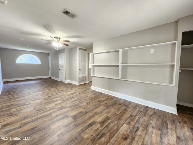 unfurnished living room with dark hardwood / wood-style floors and ceiling fan