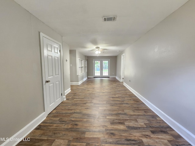 corridor with french doors and dark hardwood / wood-style flooring