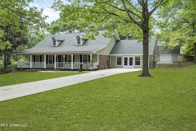 18401 Dogwood Ln, Saucier, MS 39574 - view of front of home with a front yard, a shingled roof, a porch, concrete driveway, and french doors