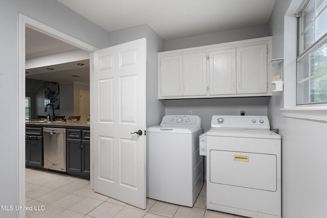 18401 Dogwood Ln, Saucier, MS 39574 - clothes washing area with separate washer and dryer, light tile patterned flooring, a sink, and cabinet space