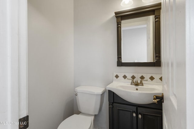 18401 Dogwood Ln, Saucier, MS 39574 - bathroom featuring toilet, decorative backsplash, and vanity